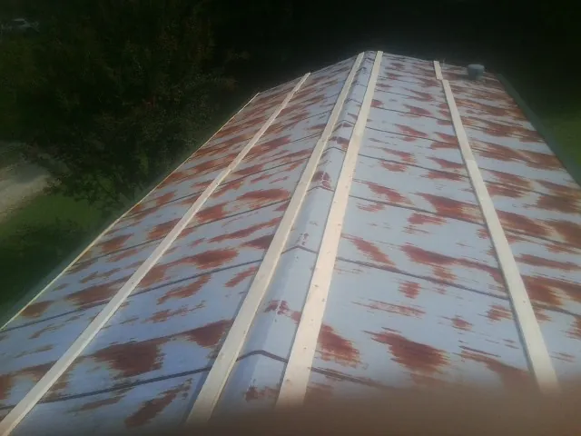 Rusted metal roof panels with new wood purlins before replacement — Storm Damage Roof Repair in Kearny by Roofing Brothers