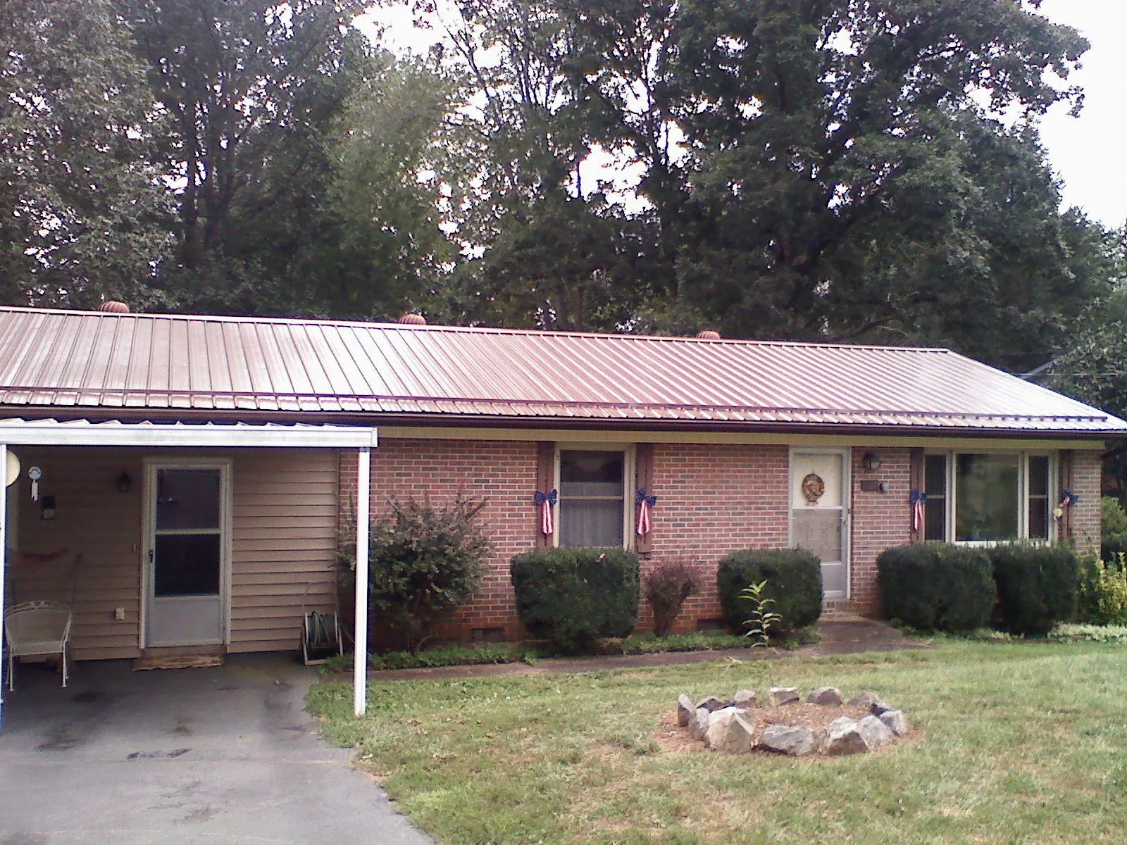 Bronze metal roof and carport on a brick ranch home — Roof Repair work by our crew in Kearny