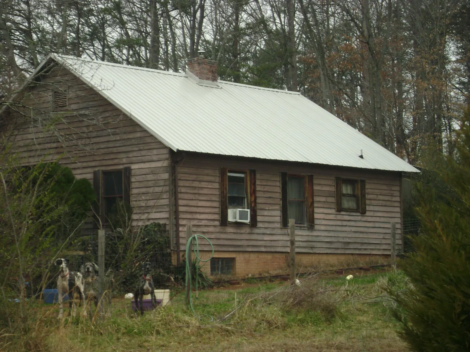 White metal roof on an old wood sided farmhouse, from a Metal Roof Installation job in Kearny